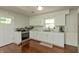 Well-lit kitchen with white cabinets, marble countertops, and stainless steel appliances at 3225 25Th St, Columbus, IN 47203