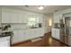 Bright kitchen with white cabinets, marble countertops, and stainless steel appliances at 3225 25Th St, Columbus, IN 47203
