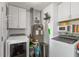 Well-equipped laundry room featuring a washer, dryer, and ample storage cabinets, plus a furnace and space-saving design at 3225 25Th St, Columbus, IN 47203