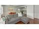 Open-concept living room features a gray sofa, dining area, and updated kitchen at 3225 25Th St, Columbus, IN 47203