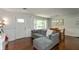 Sun-filled living room with hardwood floors, comfortable gray sofa, and large windows at 3225 25Th St, Columbus, IN 47203