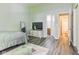 Bright bedroom with gray walls, wood floors, neutral bedding, and ensuite bathroom at 3620 N Lakeside Dr, Muncie, IN 47304