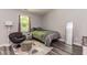 Bedroom with modern decor, including a bed with neutral bedding, stylish chair and full length mirror at 3620 N Lakeside Dr, Muncie, IN 47304