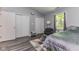 Cozy bedroom featuring gray walls, carpet, neutral accents, and natural light at 3620 N Lakeside Dr, Muncie, IN 47304