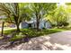 Charming home with mature trees, blue siding, and a well-maintained lawn at 3620 N Lakeside Dr, Muncie, IN 47304