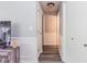 Hallway features modern wainscoting, grey paint, wood-look flooring, and white doors at 3620 N Lakeside Dr, Muncie, IN 47304