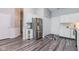 Modern kitchen with stainless steel appliances, white cabinets, and stylish gray flooring at 3620 N Lakeside Dr, Muncie, IN 47304