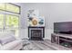 Living room featuring gas fireplace, and a plush white chair at 3620 N Lakeside Dr, Muncie, IN 47304