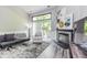 Bright living room showcasing fireplace, sliding glass doors to patio, and neutral interior paint at 3620 N Lakeside Dr, Muncie, IN 47304