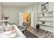 Open office with built-in shelving, gray walls, and view to entry foyer at 3620 N Lakeside Dr, Muncie, IN 47304