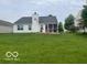 Spacious backyard features a screened-in patio, mature trees, and an expansive lawn at 3861 Indigo Blue Blvd, Whitestown, IN 46075
