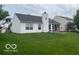 Well-maintained backyard featuring a screened-in porch and a charming chimney with patriotic decor at 3861 Indigo Blue Blvd, Whitestown, IN 46075