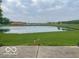 Lush backyard featuring a serene pond and expansive green space, perfect for outdoor activities at 3861 Indigo Blue Blvd, Whitestown, IN 46075