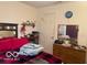 Bedroom featuring a comfortable bed, soft lighting, and a window with privacy curtains at 3861 Indigo Blue Blvd, Whitestown, IN 46075