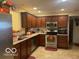 Kitchen with wood cabinets, stainless steel appliances, and tile flooring at 3861 Indigo Blue Blvd, Whitestown, IN 46075