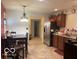 Bright kitchen with stainless steel refrigerator, dark wood cabinets, and tile floor at 3861 Indigo Blue Blvd, Whitestown, IN 46075