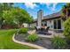 Relaxing backyard with patio seating, lush plants, and a manicured lawn at 3916 St Simons Ct, Indianapolis, IN 46237