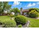 Serene backyard with patio seating, mature trees, and colorful flower arrangements at 3916 St Simons Ct, Indianapolis, IN 46237