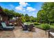 Outdoor patio featuring a dining table and swing, offering serene views of the landscaped backyard at 3916 St Simons Ct, Indianapolis, IN 46237