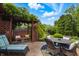 Serene backyard patio with a swing and table, surrounded by lush greenery, providing a tranquil escape at 3916 St Simons Ct, Indianapolis, IN 46237