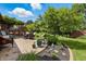 Backyard patio area with mature plantings, a dining set, and a trellis with swing, perfect for outdoor living at 3916 St Simons Ct, Indianapolis, IN 46237