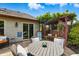 Outdoor patio showcasing a dining table, swing, and meticulous landscaping, perfect for relaxation at 3916 St Simons Ct, Indianapolis, IN 46237