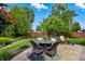 Inviting backyard patio featuring a charming dining set, lush greenery, and a well-maintained lawn at 3916 St Simons Ct, Indianapolis, IN 46237