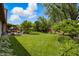 Lush backyard with green lawn, mature trees, manicured beds, and a patio, perfect for outdoor enjoyment at 3916 St Simons Ct, Indianapolis, IN 46237