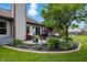 Beautifully landscaped backyard with patio seating area and lush greenery under a blue sky at 3916 St Simons Ct, Indianapolis, IN 46237