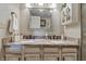 Bathroom featuring double sinks, granite countertops, vanity, and a large mirror for a bright, open feel at 3916 St Simons Ct, Indianapolis, IN 46237