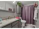 Bathroom featuring a sink, toilet, shower with a curtain, cabinet, and a mirror, combining style and functionality at 3916 St Simons Ct, Indianapolis, IN 46237