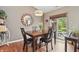 Dining room with a sliding glass door, and wood dining table illuminated by a modern chandelier at 3916 St Simons Ct, Indianapolis, IN 46237