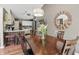 Dining room area adjacent to the kitchen featuring wood floors and an elegant lighting fixture at 3916 St Simons Ct, Indianapolis, IN 46237