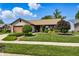 Charming single-story home featuring a manicured lawn and beautiful landscaping at 3916 St Simons Ct, Indianapolis, IN 46237