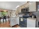 Open kitchen with stainless steel appliances and views of the dining and living areas at 3916 St Simons Ct, Indianapolis, IN 46237