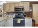 Kitchen with light countertops, updated appliances, and ample cabinet space at 3916 St Simons Ct, Indianapolis, IN 46237