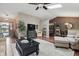 Cozy living room featuring a ceiling fan, skylight, neutral tones and a decorative fireplace at 3916 St Simons Ct, Indianapolis, IN 46237