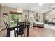 Open-concept living and dining area with hardwood floors and a large window at 3916 St Simons Ct, Indianapolis, IN 46237