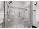 Elegant glass-enclosed shower with tiled walls, built-in bench, and modern fixtures for a spa-like experience at 3916 St Simons Ct, Indianapolis, IN 46237