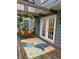 Outdoor porch featuring a swing seat with floral pillows and a decorative rug adding charm at 4619 N Park Ave, Indianapolis, IN 46205