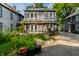 Exterior shot of a charming two-story home with a garden, pergola and well-kept lawn at 4619 N Park Ave, Indianapolis, IN 46205
