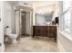 Bathroom featuring glass-enclosed shower, toilet, and classic vanity with granite countertop and decorative mirror at 4619 N Park Ave, Indianapolis, IN 46205