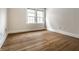 Bright bedroom showcasing hardwood floors and natural light from large windows, offering a versatile space at 4619 N Park Ave, Indianapolis, IN 46205