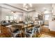 Inviting dining room featuring a rustic wood table set for dinner, seamlessly connected to a bright, modern kitchen at 4619 N Park Ave, Indianapolis, IN 46205