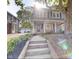Charming two-story home featuring a welcoming front porch and landscaped garden leading to the front door at 4619 N Park Ave, Indianapolis, IN 46205