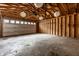 Spacious garage with exposed rafters and ample room for parking and storage at 4619 N Park Ave, Indianapolis, IN 46205