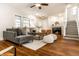 Elegant living room showcasing hardwood floors, a fireplace, and an open staircase at 4619 N Park Ave, Indianapolis, IN 46205