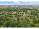 A beautiful aerial view of this neighborhood, including trees, homes, and streets beneath a partly cloudy sky at 4645 Quail Run Dr, New Palestine, IN 46163
