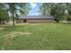 Spacious backyard featuring a brick home exterior and lush greenery at 4645 Quail Run Dr, New Palestine, IN 46163