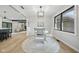 Bright dining area features a stylish light fixture and round rug under a white table and chairs at 4645 Quail Run Dr, New Palestine, IN 46163